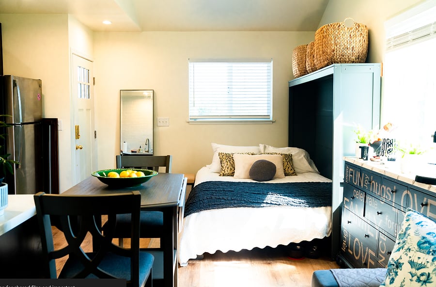Murphy bed that folds up for lots of extra room, baskets for pillows and blankets ,sheets or storage