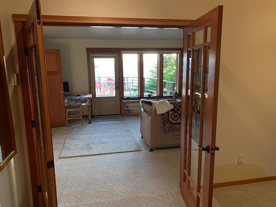 Looking to the living area from the bedroom and out to the deck.