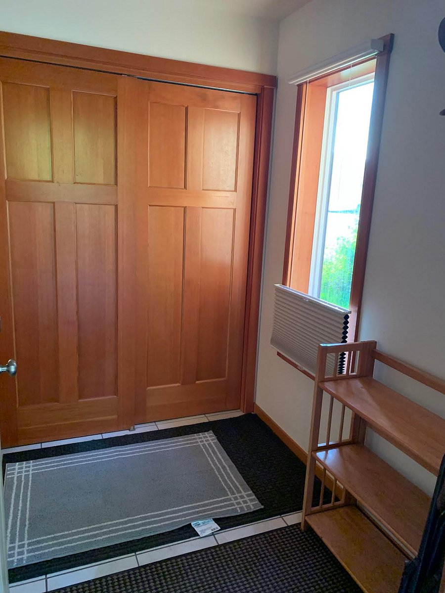 Entryway. Closet behind the wooden sliding doors.