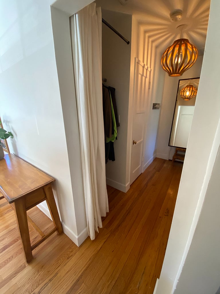 Hallway with hanging closet and shelved closet