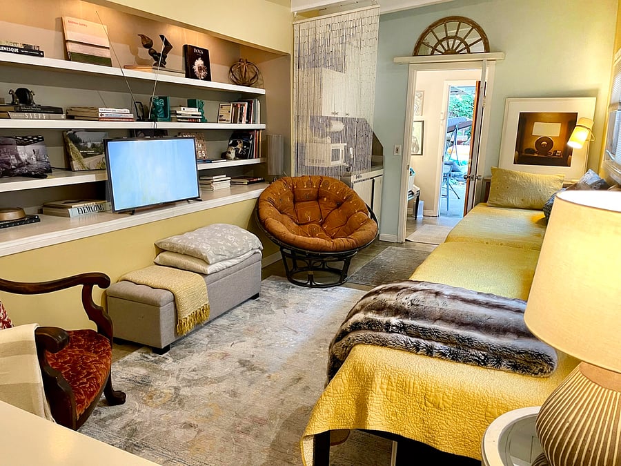 Another view of main room, with TV.  Kitchenette on other side of hanging beads. Work area with desk is cropped out of this picture, but located in the foreground.