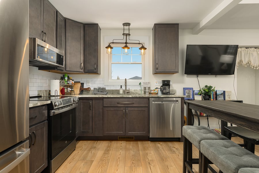 Fully stocked kitchen with stainless appliances and dishwasher