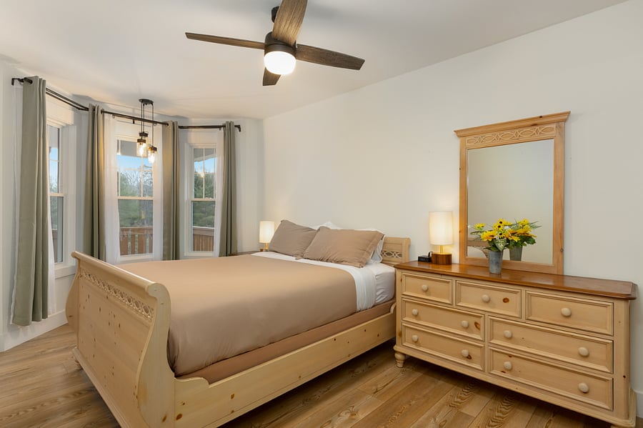Master bedroom with queen bed, full dresser and walk/in closet
