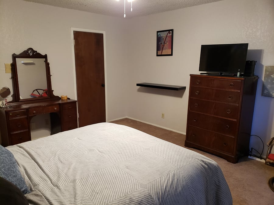 The main bedroom offers a flat screen TV and ample shelf space.