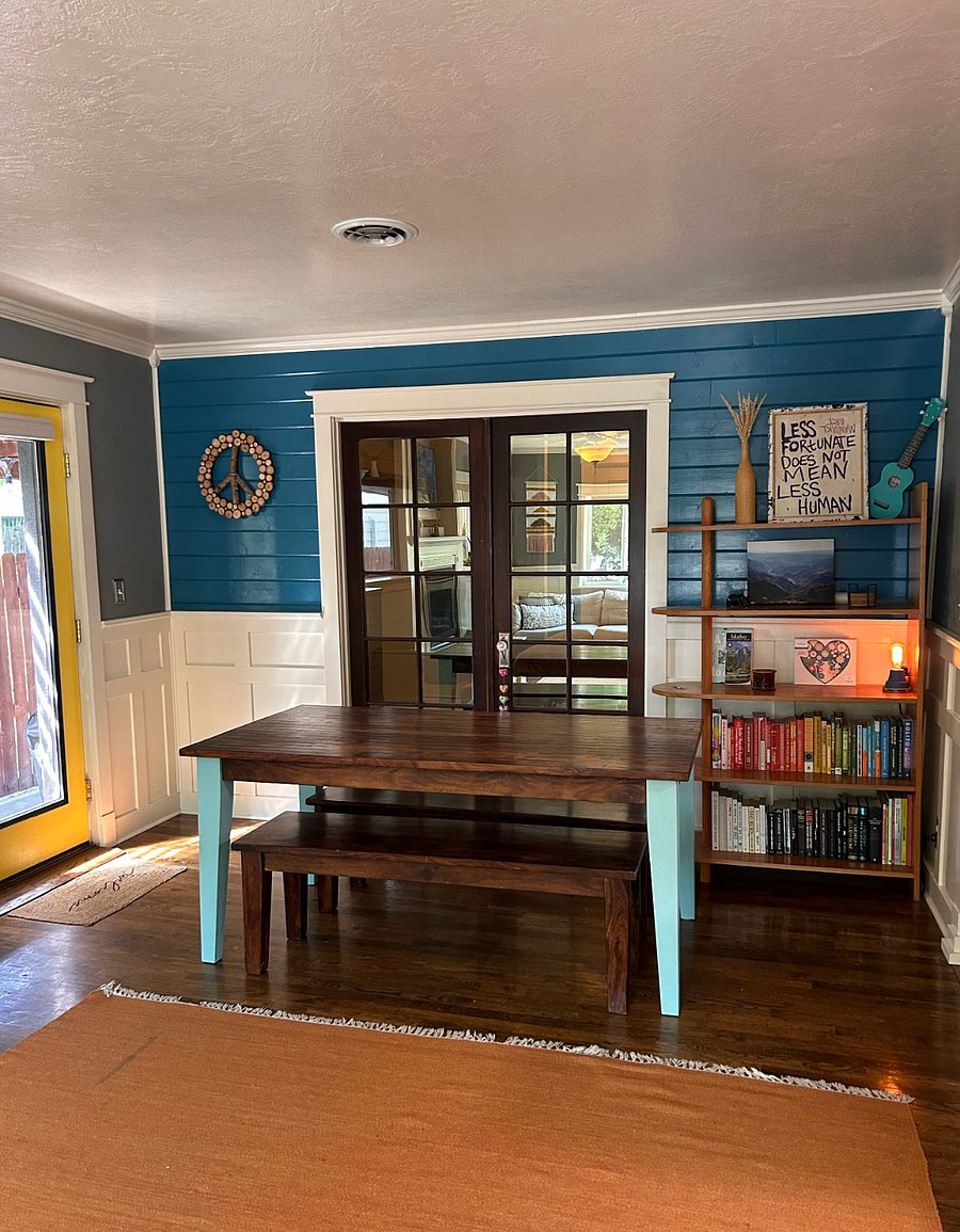 Dining table and books on the other side of the living room.