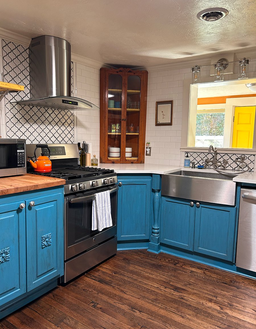 There is a microwave, gas stove, dishwasher, coffee pot, and large farmhouse sink.