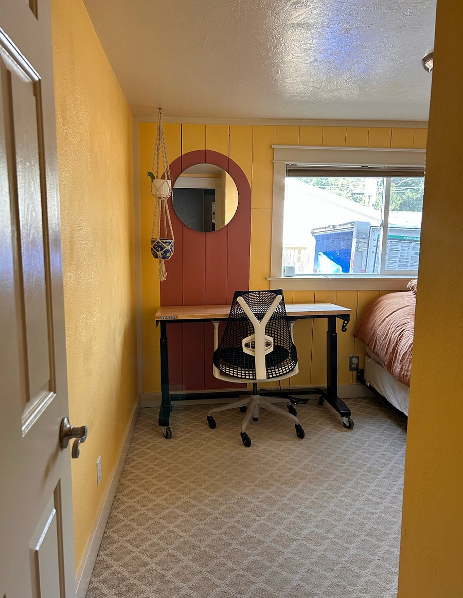 The secondary bedroom has a queen sized bed and standing desk.