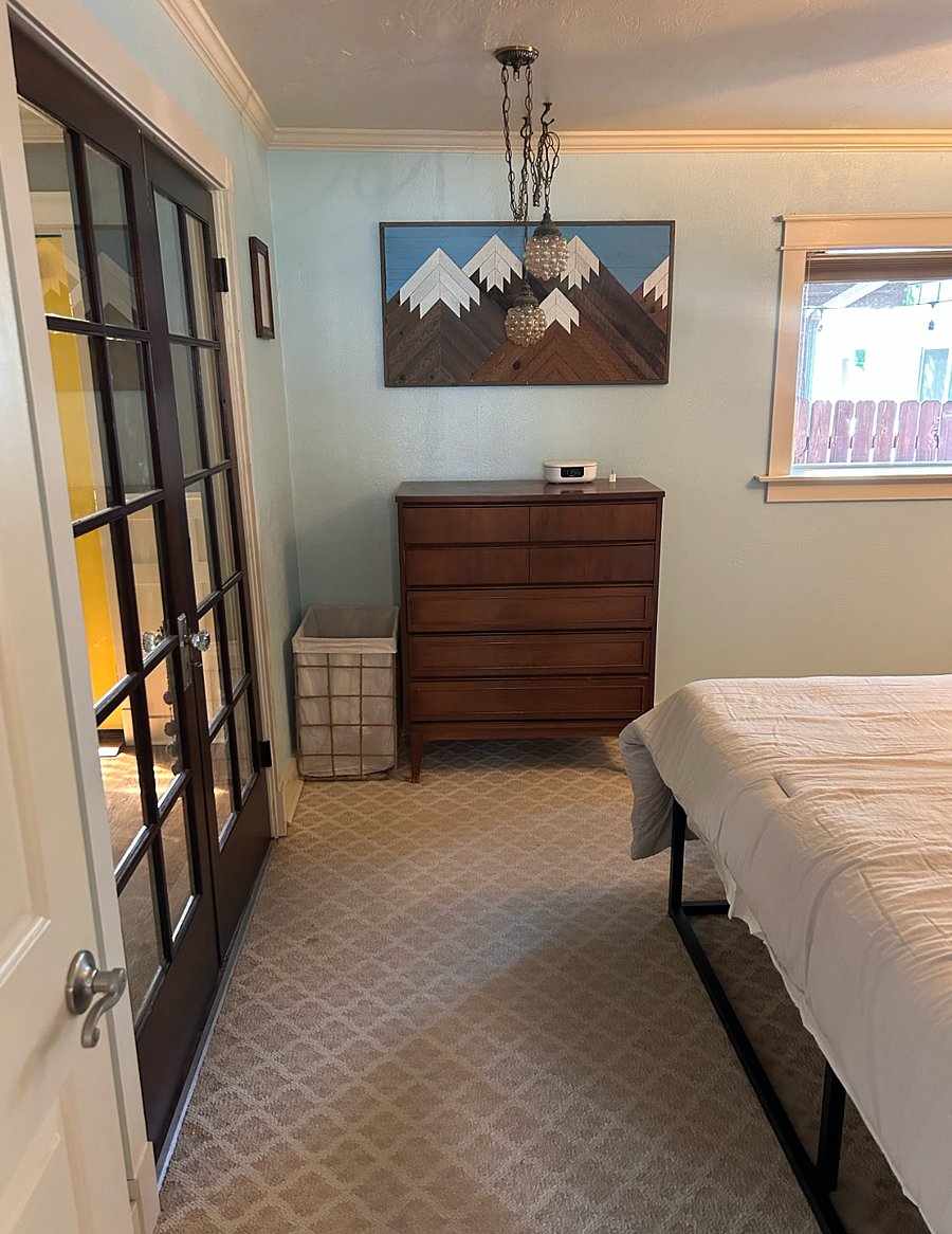 The primary bedroom has a king bed, large dresser and closet, and vanity.