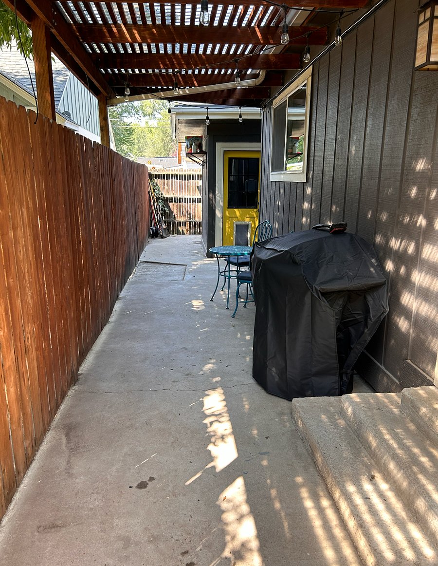 Off of the living / dining room, there is a covered alley with a grill and access to a shed for more storage.