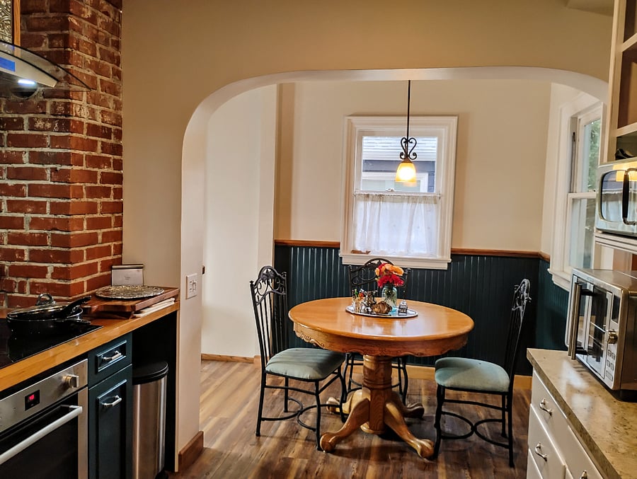 Kitchen table is expandable with hidden leaf inside for extra guests.