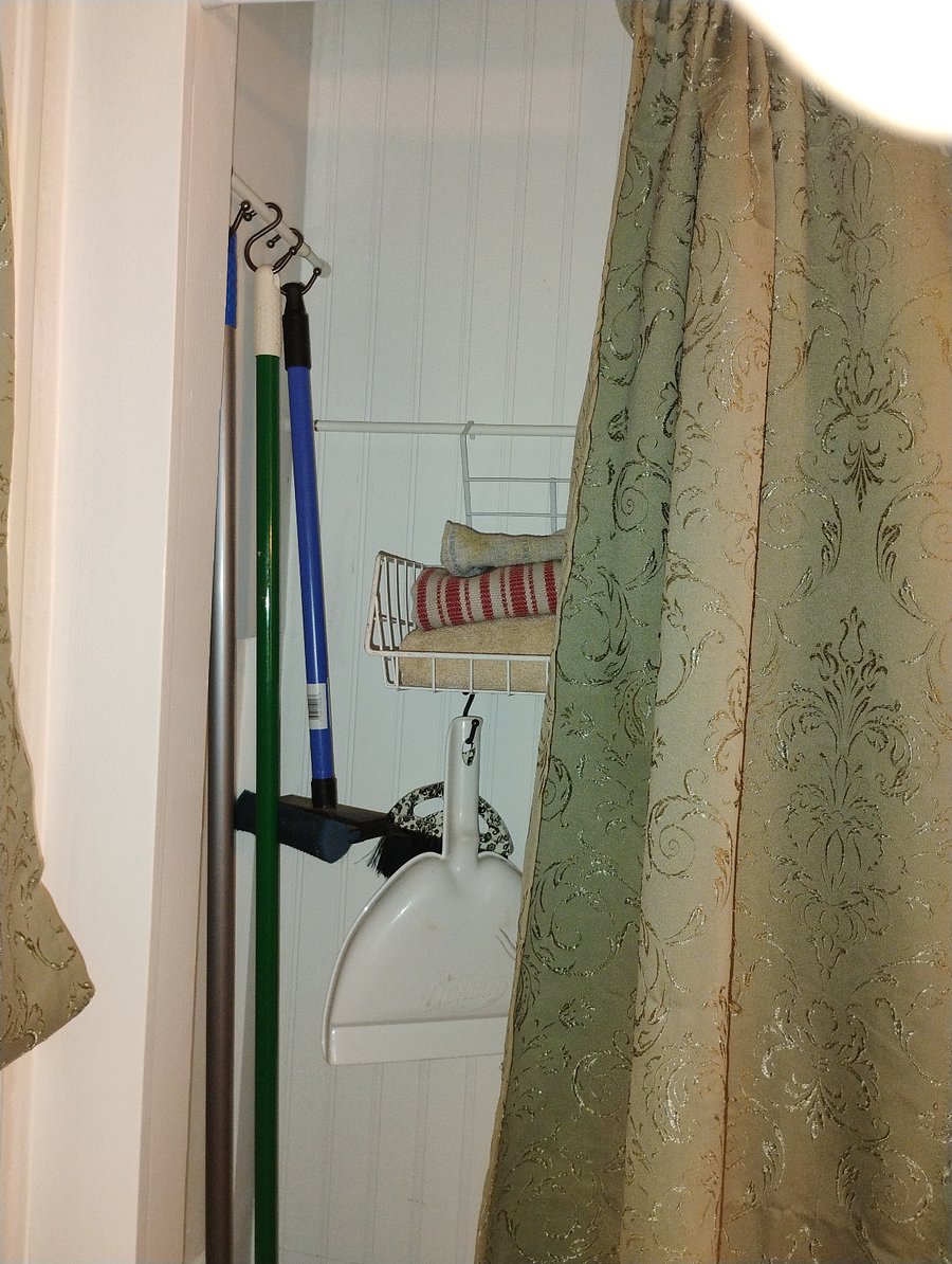 Little utility broom closet by the back laundry room door.