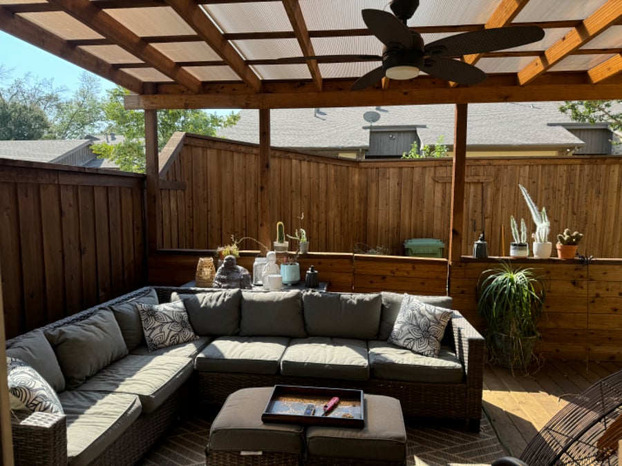 Private covered back patio with fan and TV