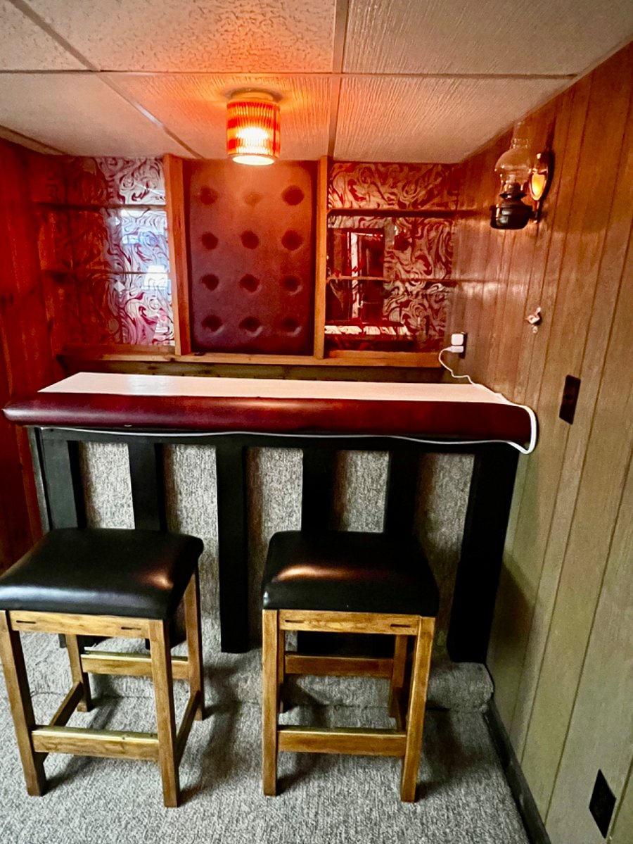 Lower level bar area. Retro with bar made out of an old piano by my dad in the 70s!