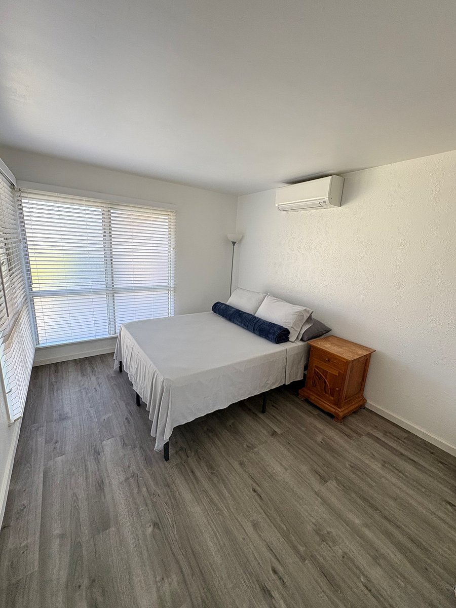 Bedroom 1: Queen size bed, 2 king size pillows, 2 queen size pillows, 1 navy colored blanket,100 cotton fitted/flat sheets/pillow cases, 1 night lamp, 1 banana leaf teak night stand, beveled mirror sliding closet door, 1 Mitsubishi split AC with remote control