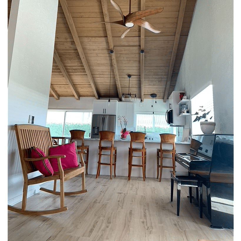 Kitchen/Living Room B, pic 2
Kitchen: 4 teak bar stools, decorative items on shelves
Living Room B: 1 black piano with bench, 1 teak rocker (double seater) with two fuchsia square pillows, 1 Minka koa ceiling fan.