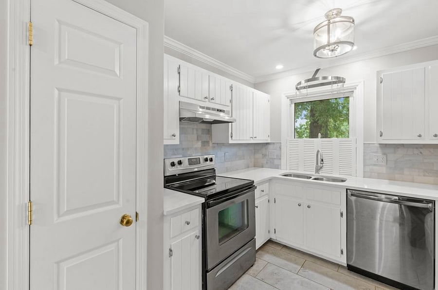 Full kitchen with quartz countertops, pantry, dishwasher, electric cooktop range, refrigerator and pleny of cabinet space.