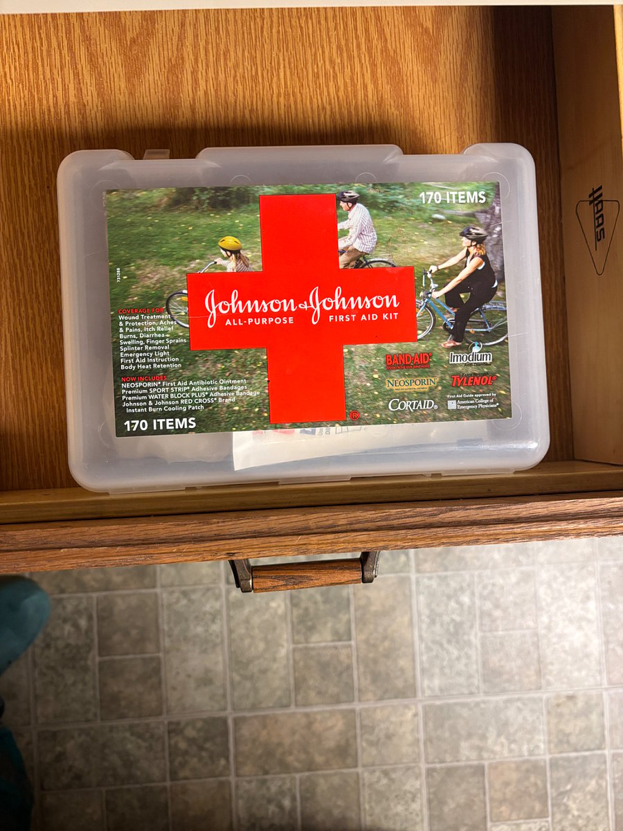 First Aid kit located at the desk  in the kitchen. 