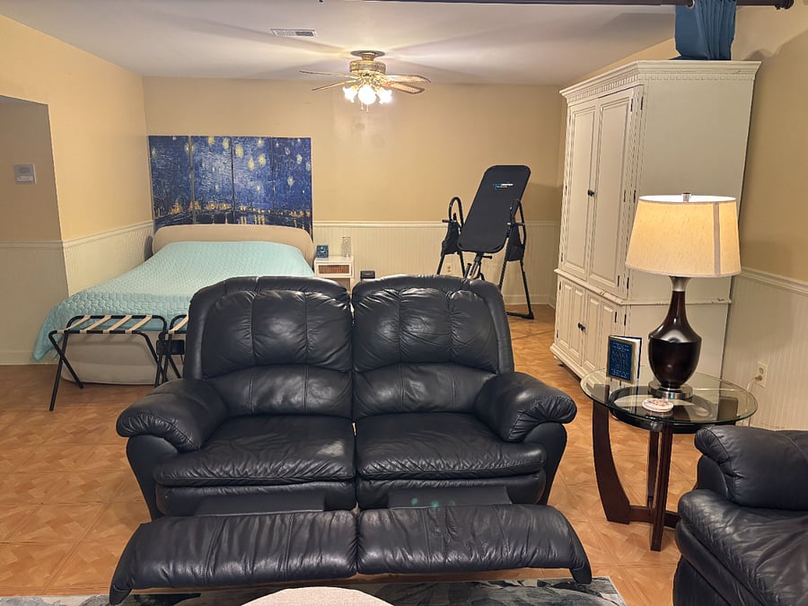 This area is next to the living room and can be sectioned off by simply pulling the navy blue black out curtains together for some quiet and privacy. The couches are leather and recline. 