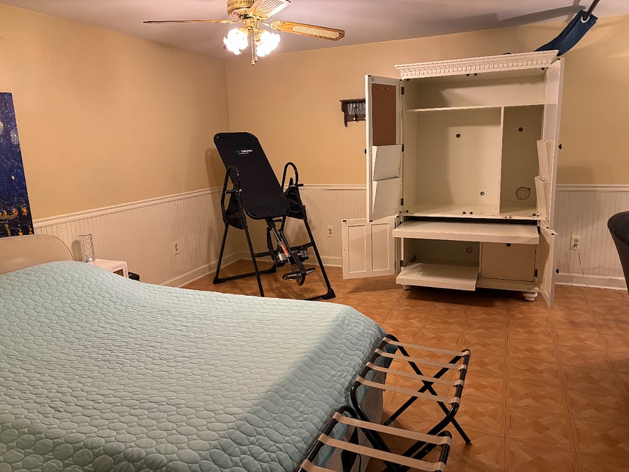 This photos shows the work station in full view. You can also utilize this for clothing, shoes and or storage. You have a ceiling fan/light, night table and waste basket. Luggage racks are also provided. 