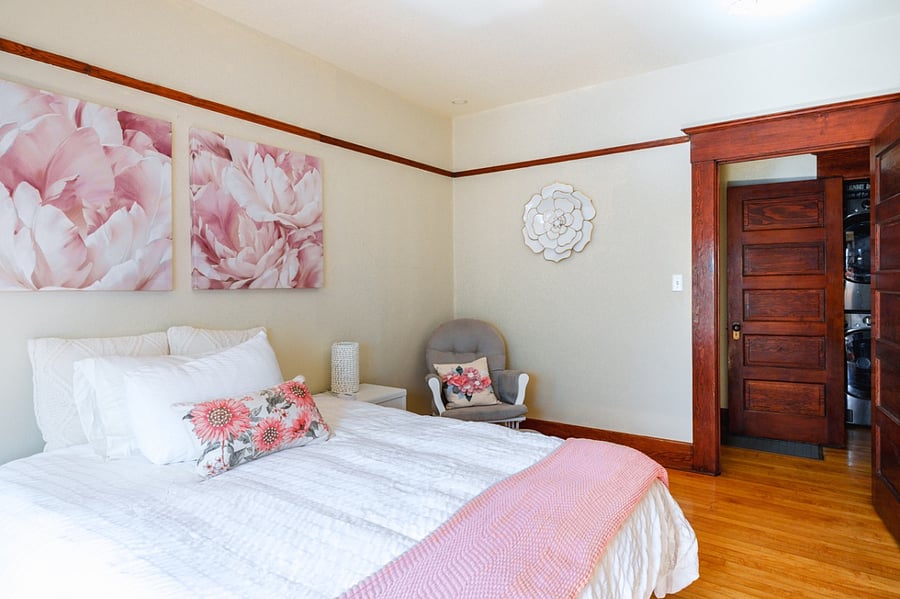 Queen bed with nursing rocker and window seating.