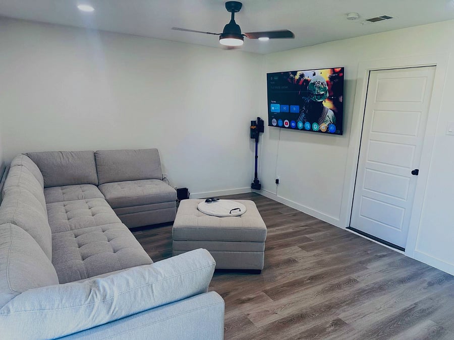 Living room/family room with 65" TV. Sofa can seat 6