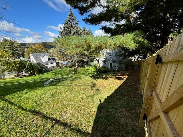 7 foot wood fence that runs down the pine tree ridgeline