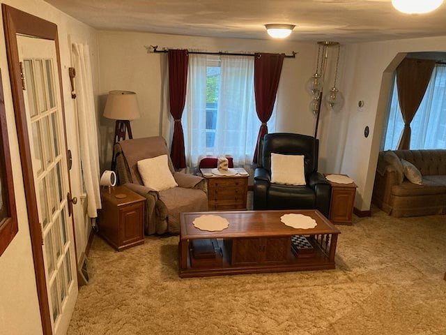 Living room. Air purifier is under the corner lamp. Coffes table has board games and crossword puzzles. 