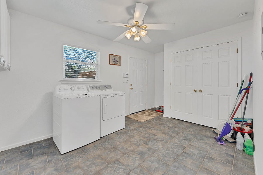 Fullsize washer and dryer located in this spacious laundry/utility room.