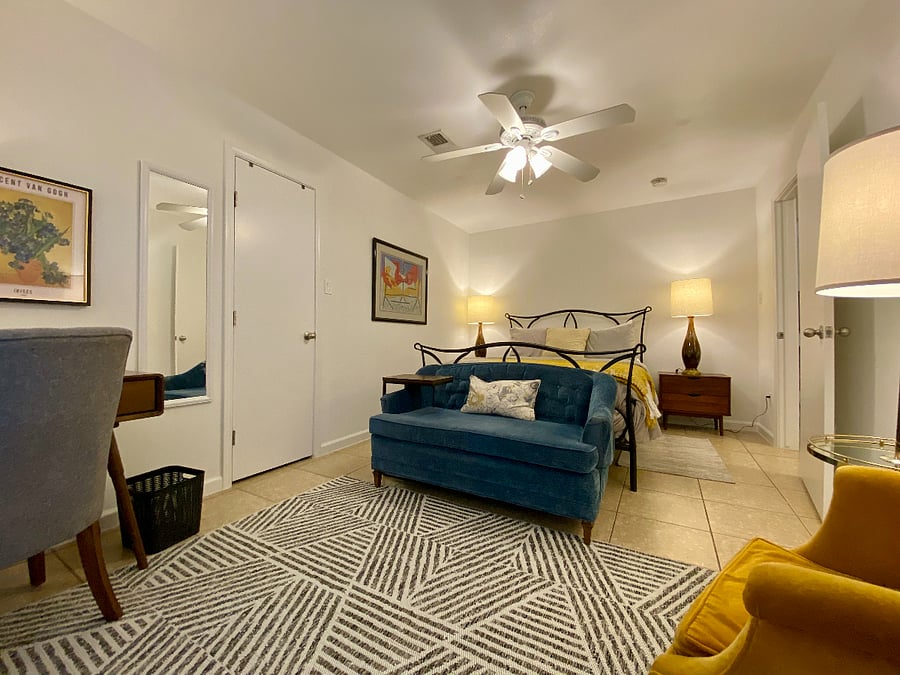 Bedroom 1 with small sitting area and desk with power plugs for all your chargin needs.