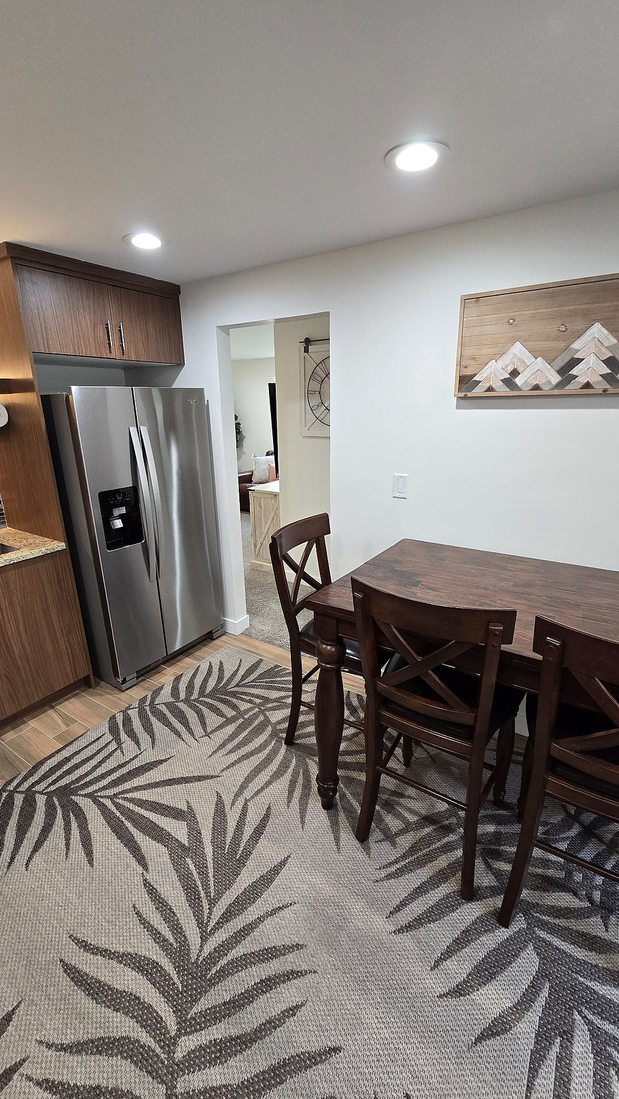 Expandable 4-top kitchen table, your refrigerator, and the hallway to your living room