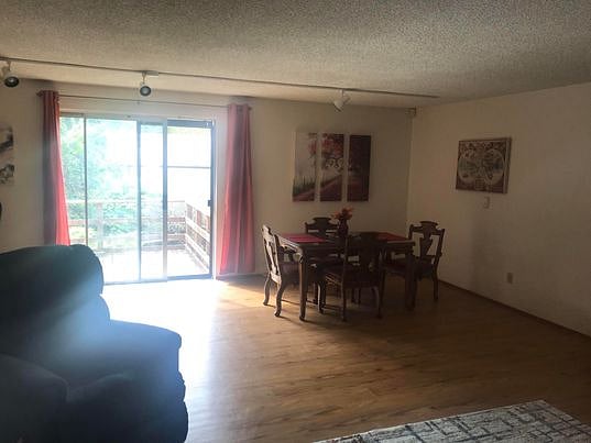 Dining area with door to deck. Lots of sunshine to brighten your day.