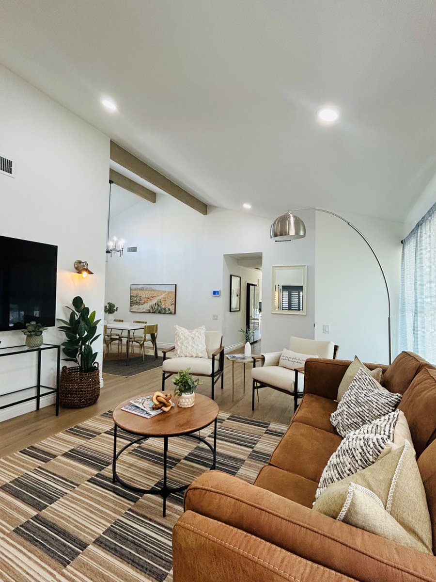 High Vaulted Ceiling in Formal Dining with adjacent living room equipped with large flat screen TV