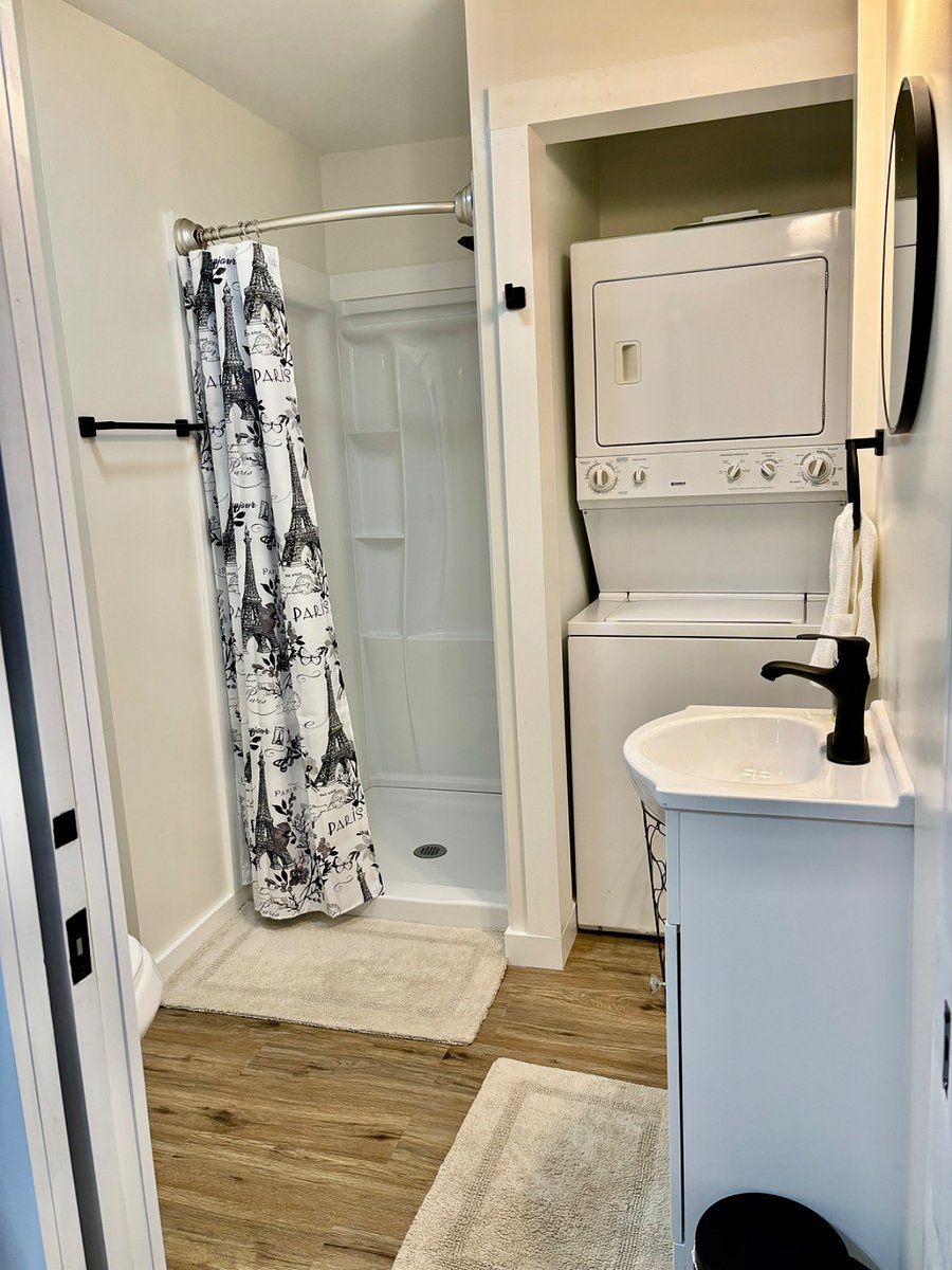Bathroom with shower. Stackable washer and dryer. Stocked with towels and wash clothes. Starter toiletries.