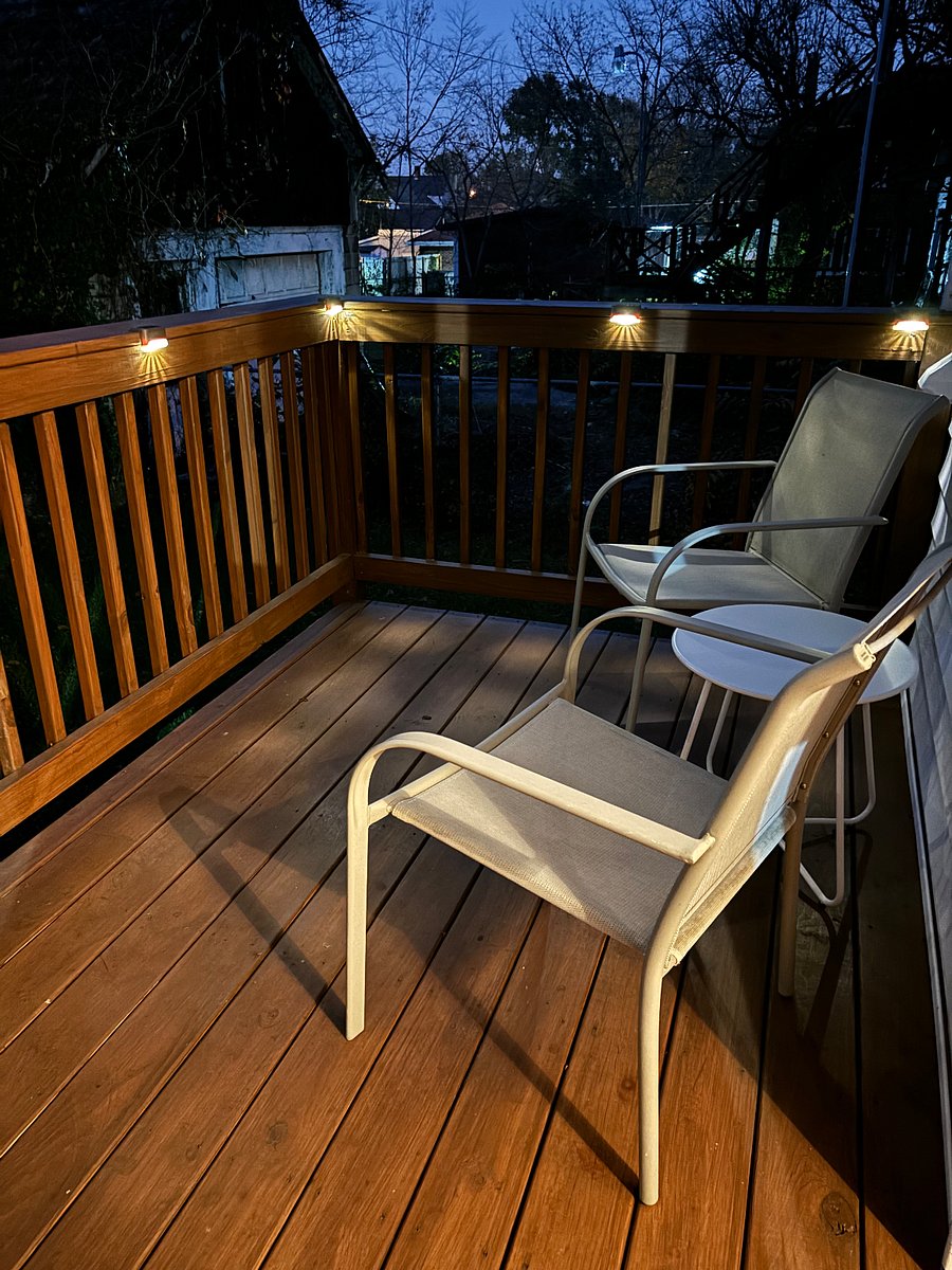 Back private deck with 2 chairs and solar lighting.