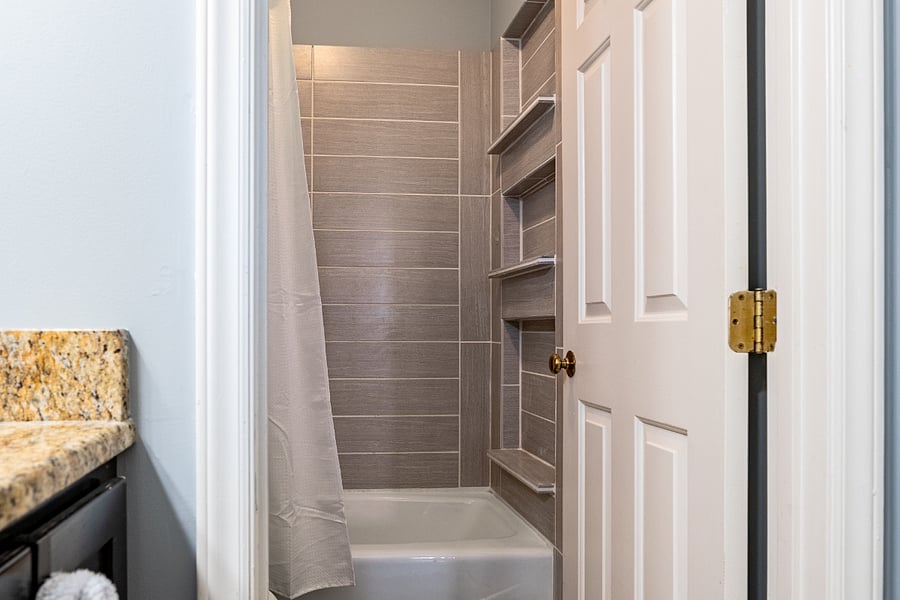 Primary ensuite bathroom with tub shower combo.  