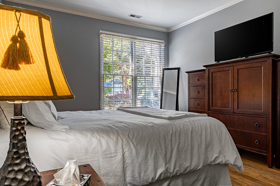 Primary bedroom with smart TV and dresser