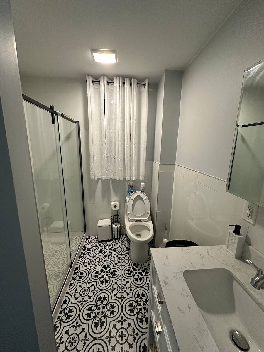 Bathroom Photo: "Sparkling clean modern bathroom stocked with plush towels and complimentary starter toiletries.