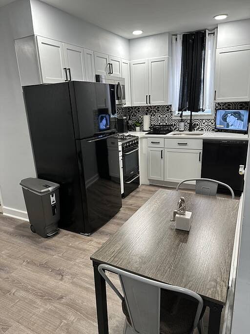 Kitchen Photo: "Chef-ready kitchen with white shaker cabinets, modern appliances, and a dishwasher for easy cleanup.