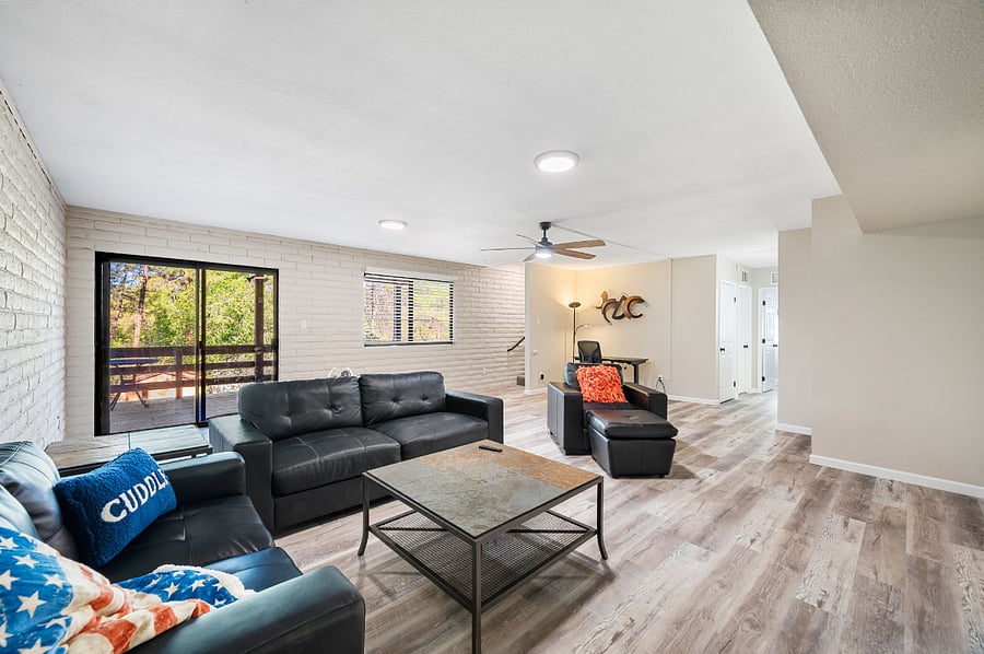 Lower level family room with work space and 85" smart TV.