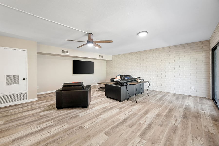 Lower level family room with work space and 85" smart TV.