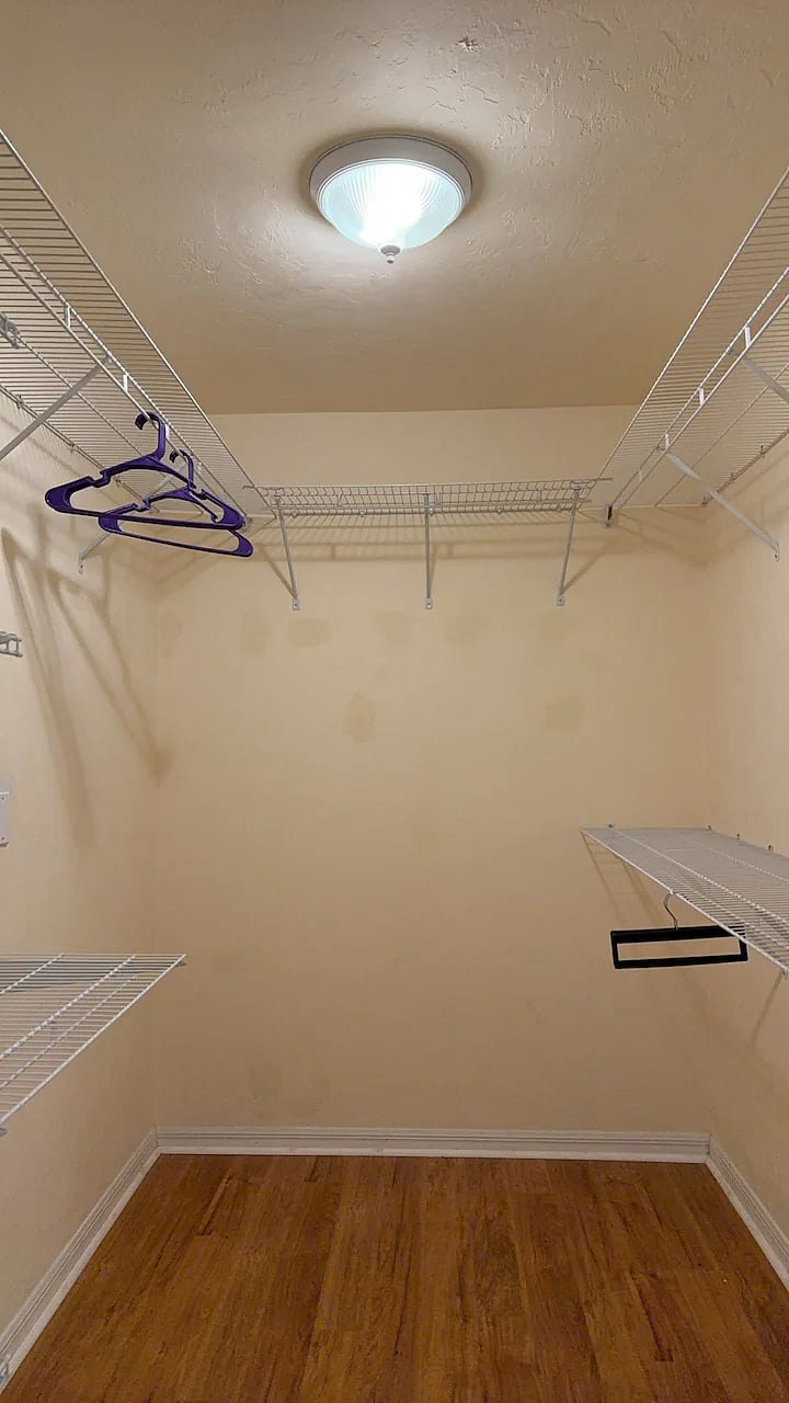 walkin closet within master bedroombed
