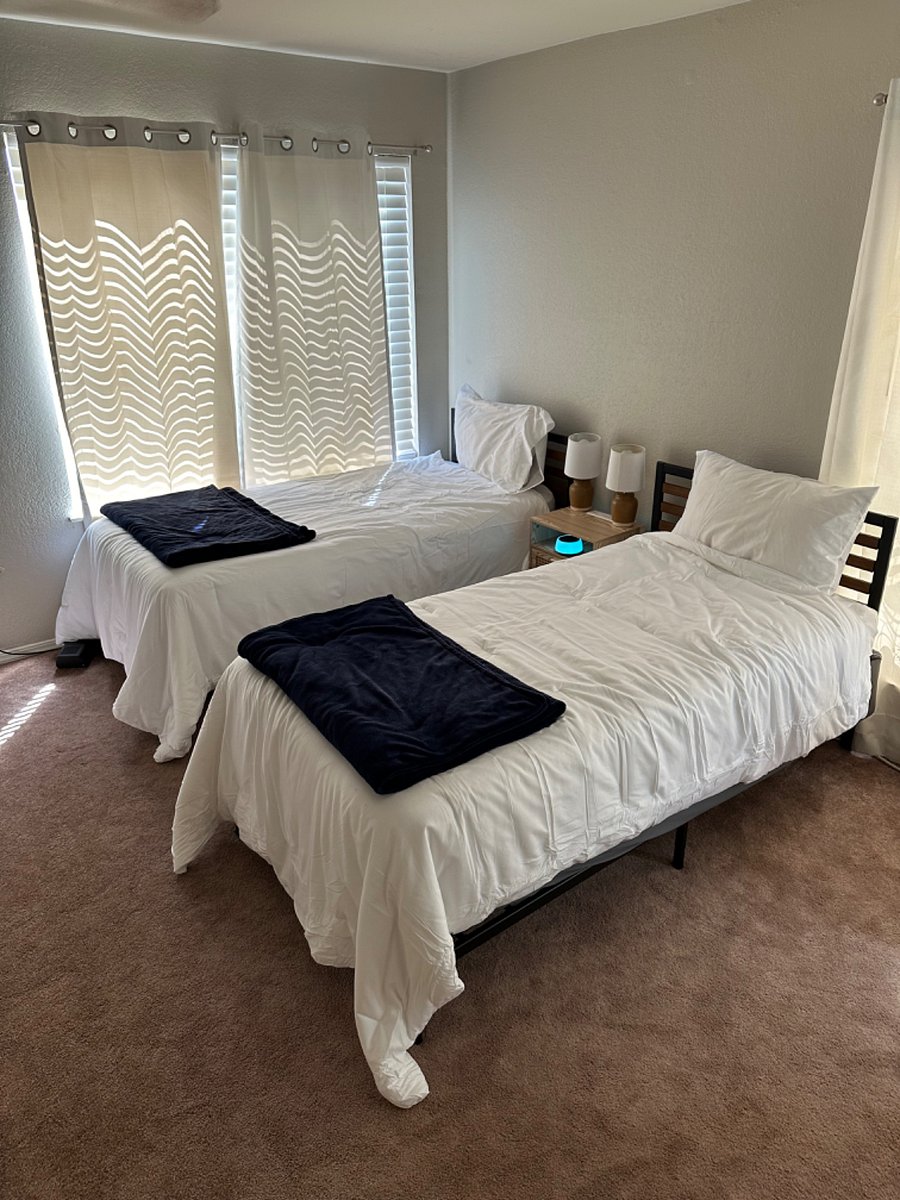 upstairs loft bedroom features two twin beds and closet