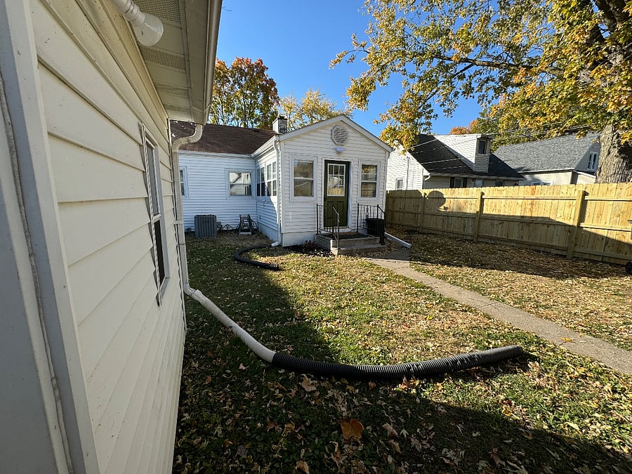 Fenced in backyard with side garage entrance inside fence