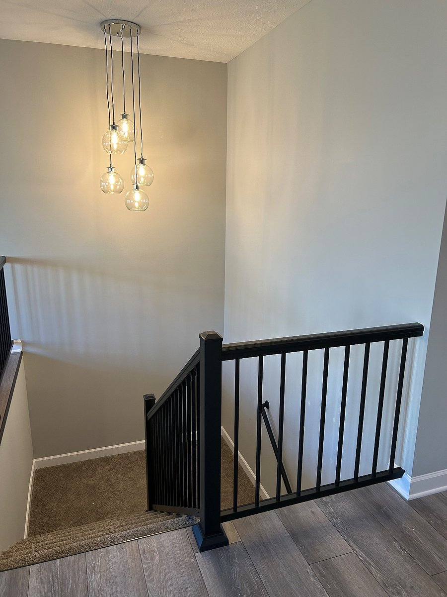 The stairwell leads to the finished basement with storage