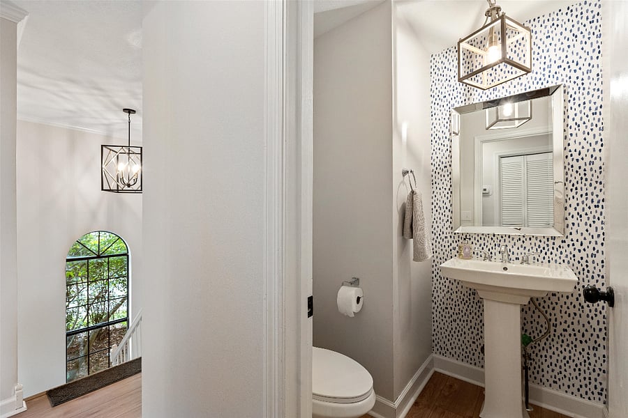 Half bath tucked away from kitchen and living area.
