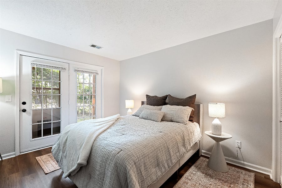 Queen bedroom below has two large closets and double glass doors leading to lower level patio and back yard of complex. 