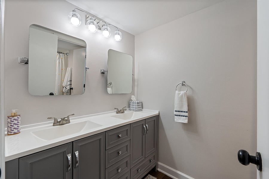 Bath has double vanities, shower and tub combo.