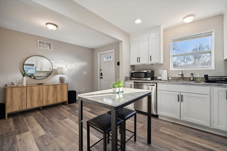 Kitchen and dining 3 with view of entrance and foyer