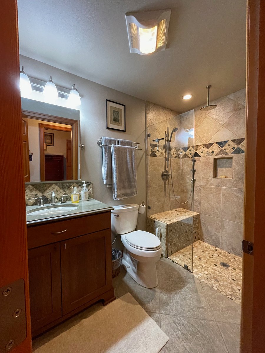 Guest bathroom: Rain shower, zero clearance shower with installed bench, heated floor