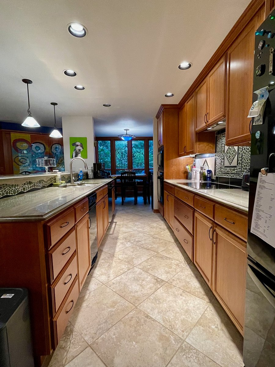 Fully stocked kitchen, heated tile floor, induction stove top, convection wall oven, microwave, trash compactor, dishwasher, refrigerator-freezer